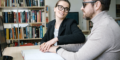 Image of man and woman reading Braille